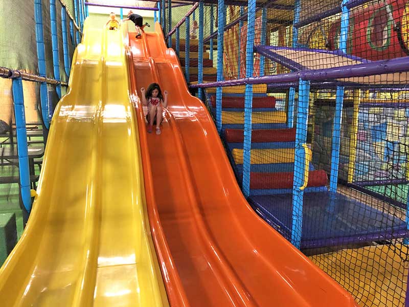 Girl riding slide at Catch Air in Grand Rapids.