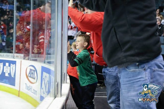 excited kids standing up griffins hockey