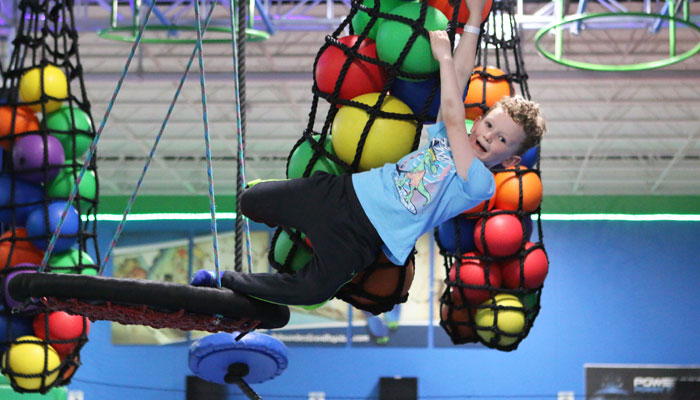 boy hanging from net at Rebounderz