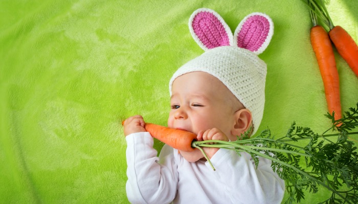 Baby eating carrot for Easter Brunch