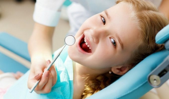 Girl in a chair seeing a Pediatric Dentist in Grand Rapids
