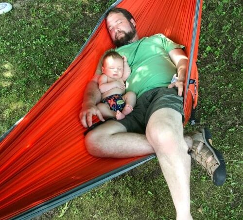 Camping boy and baby sleeping in hammock 1