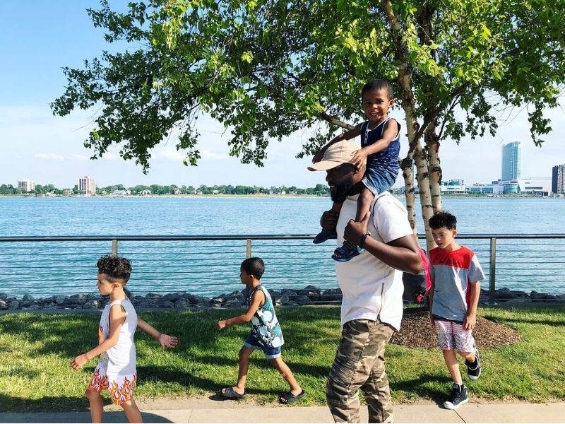 Things to do in Detroit - walk the Riverfront Dad walking with kids and nephews