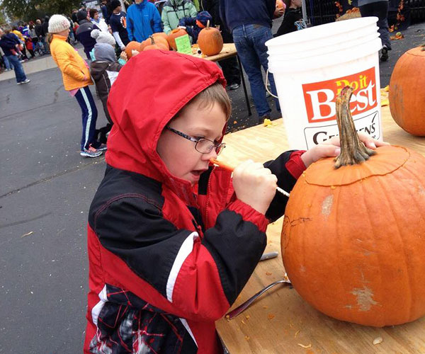 boy carving pumpkin at Urban HayDay