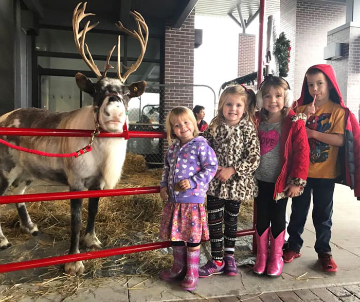 kids with reindeer at Hudsonville Holiday Parade