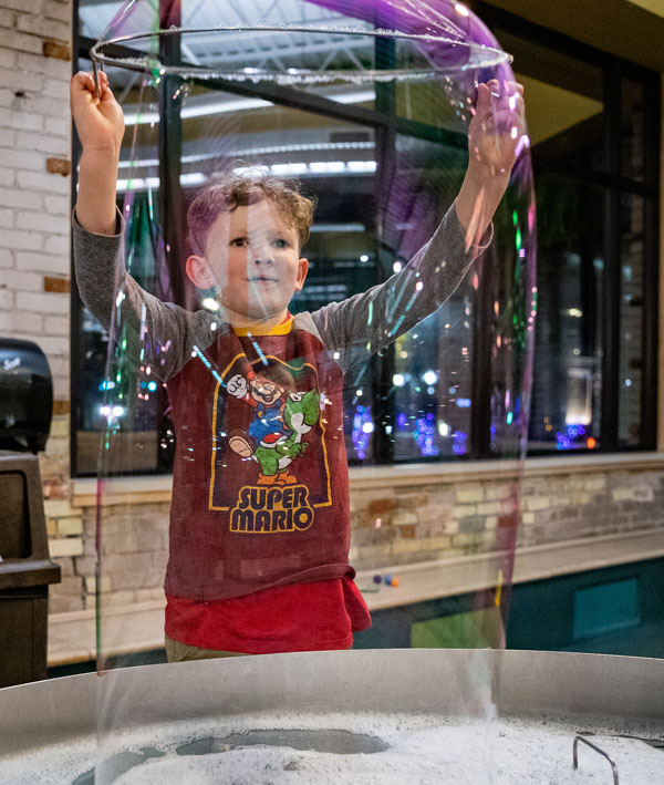 boy playing bubbles at GRCM