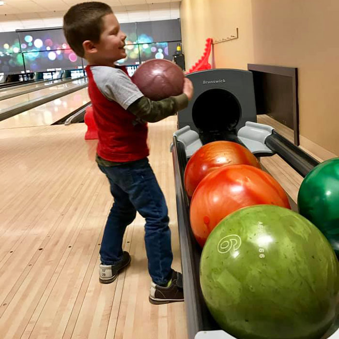Kids Bowl Free Kid getting bowling ball Lansing