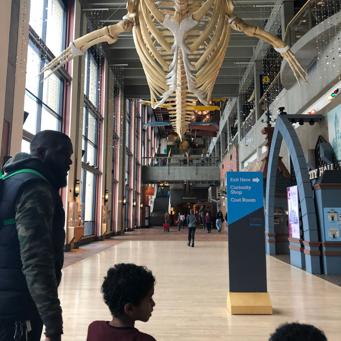 GRPM-Grand-Rapids-Public-Museum-Family-walking-in-whale-fossil