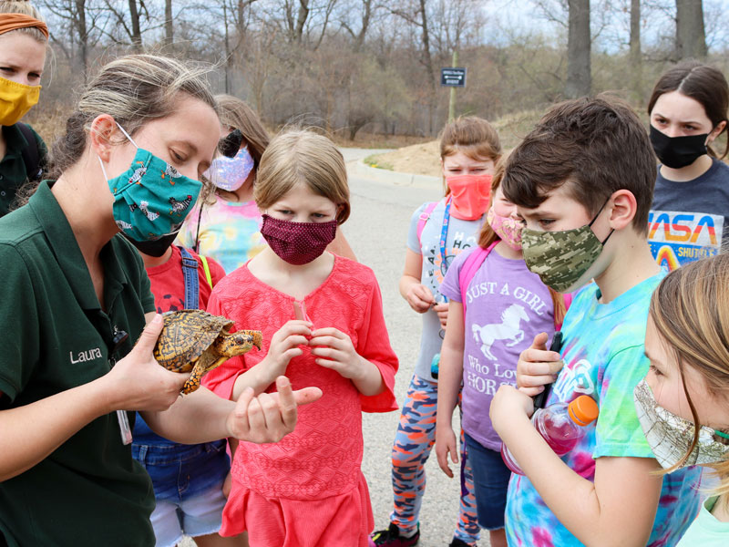 John Ball zoo staff with kids and turtle