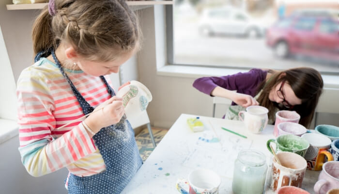 Art classes for kids includes painting pottery.