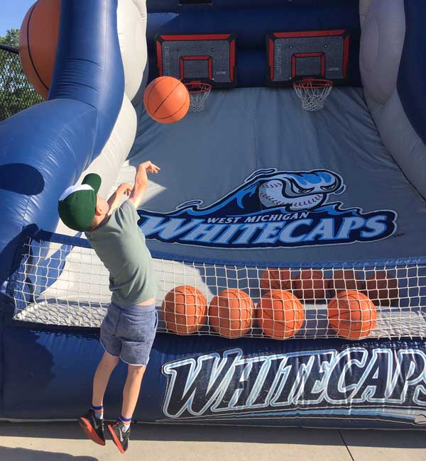 Whitecaps boy playing basketball at playground