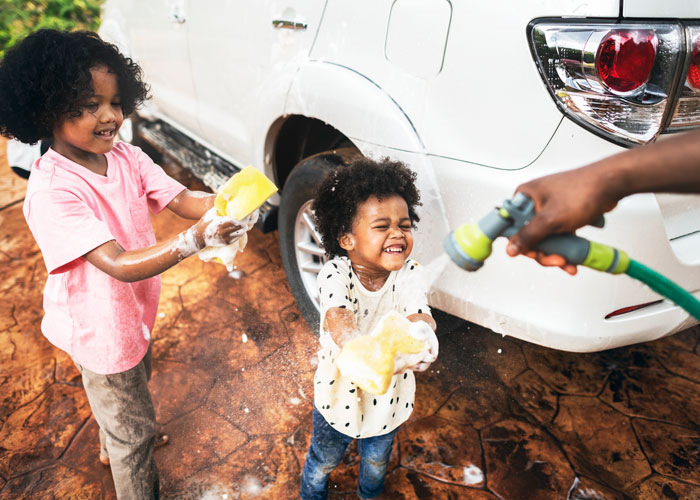 Little girls practicing car detailing. Car wash detailing in Grand Rapids gets the job done.