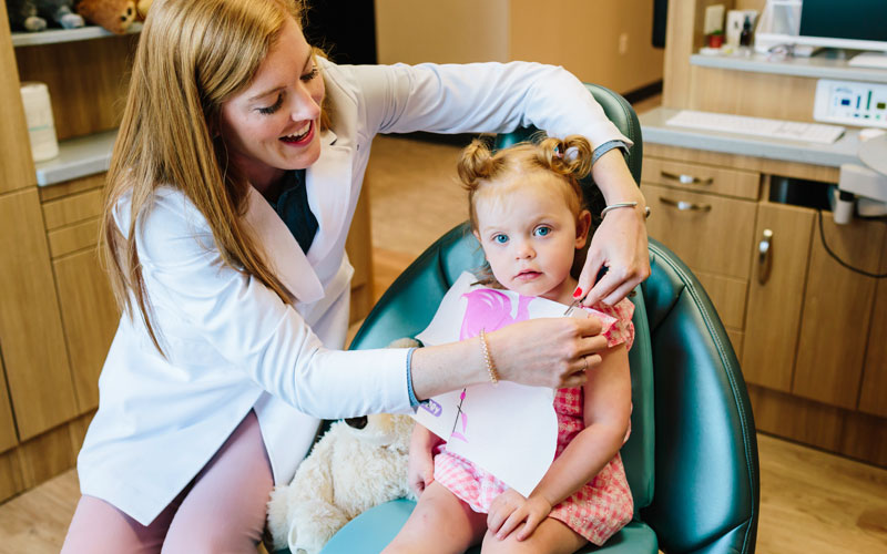 pediatric dental specialists girl in dentist chair