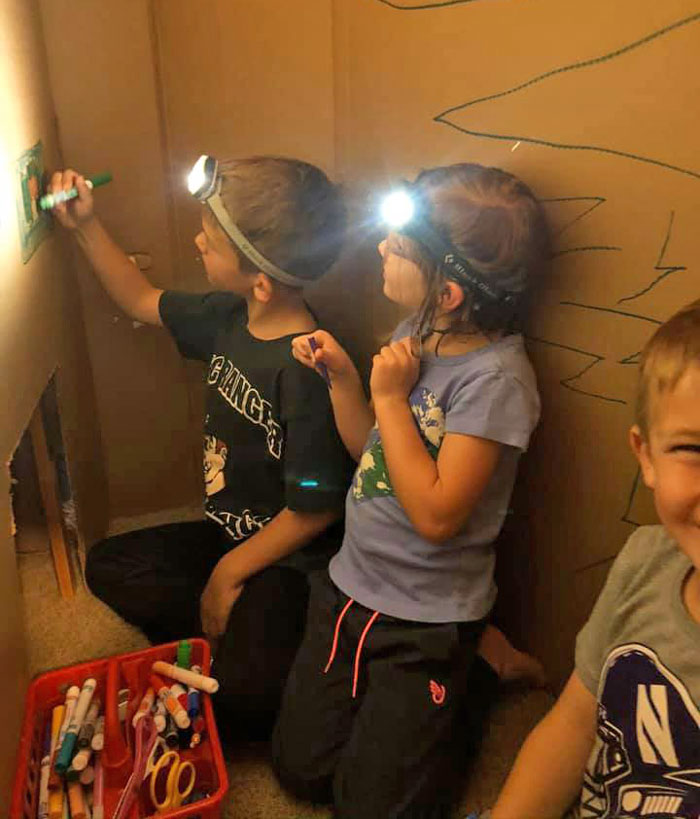 Kids making box fort with headlamps Scripps