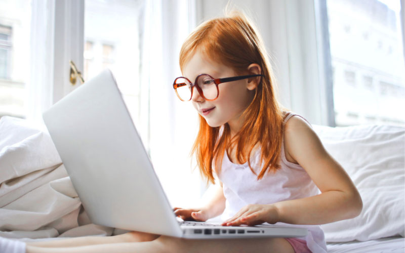 Screen time in kids girl on laptop