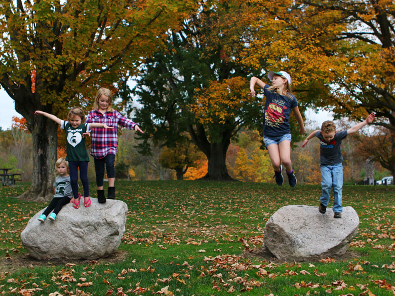 Kids jumping off rocks at Fallasburg Park Hunt