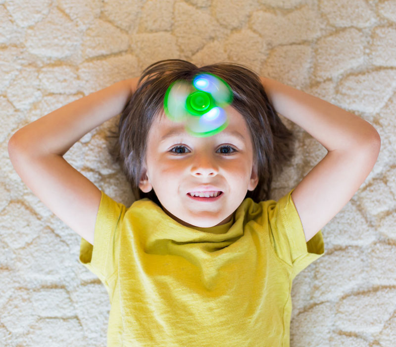 ADHD in children Metro Health happy kid with fidget spinner