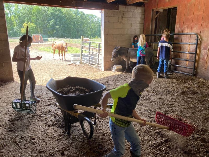 Legacy Stables Summer Camp 2021 kids in masks cleaning stable