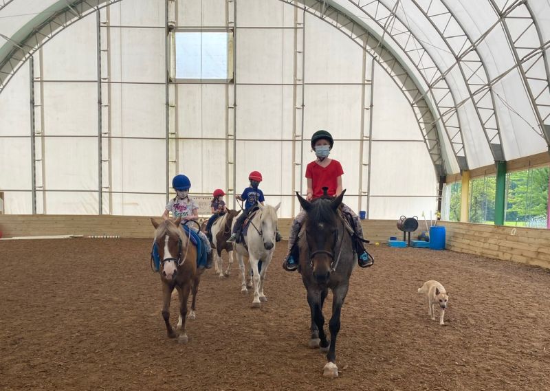 Legacy Stables Summer Camp 2021 kids in masks riding horses