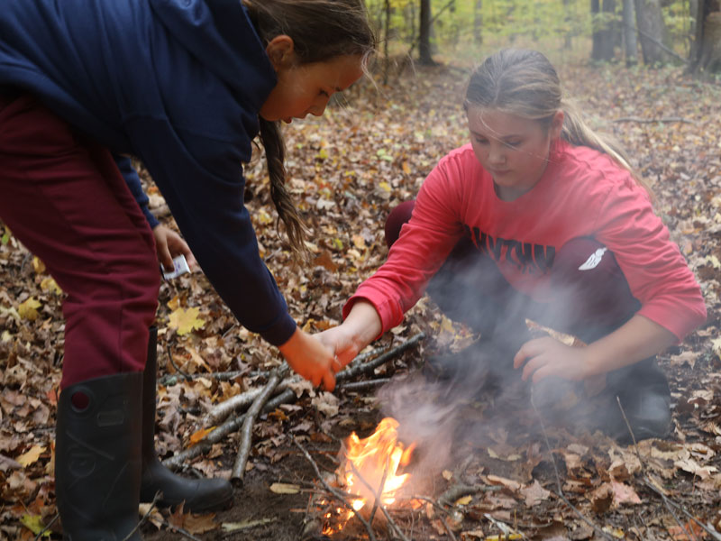 Rockford Christian GRCS grils making fire in woods