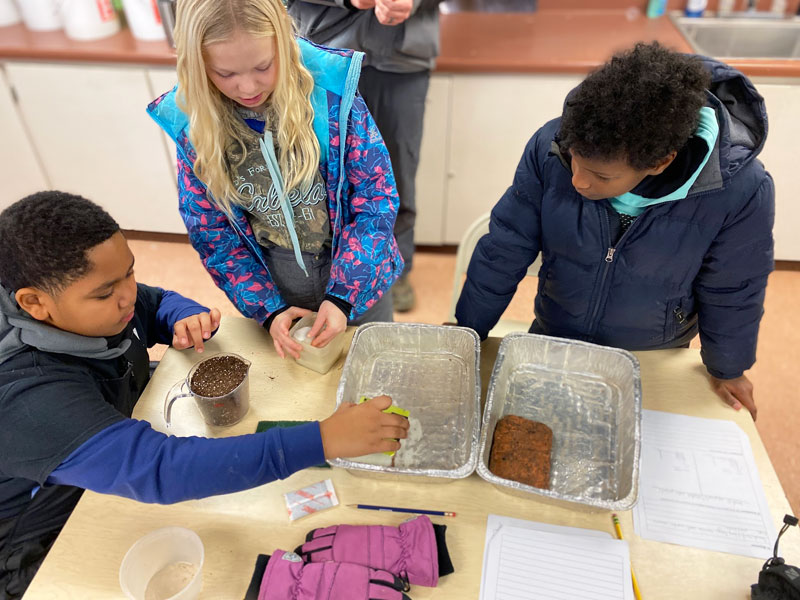 Rockford Christian GRCS students examining soil in classroom