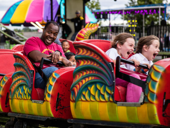 fairs in Michigan festivals : dad having fun on carnival ride