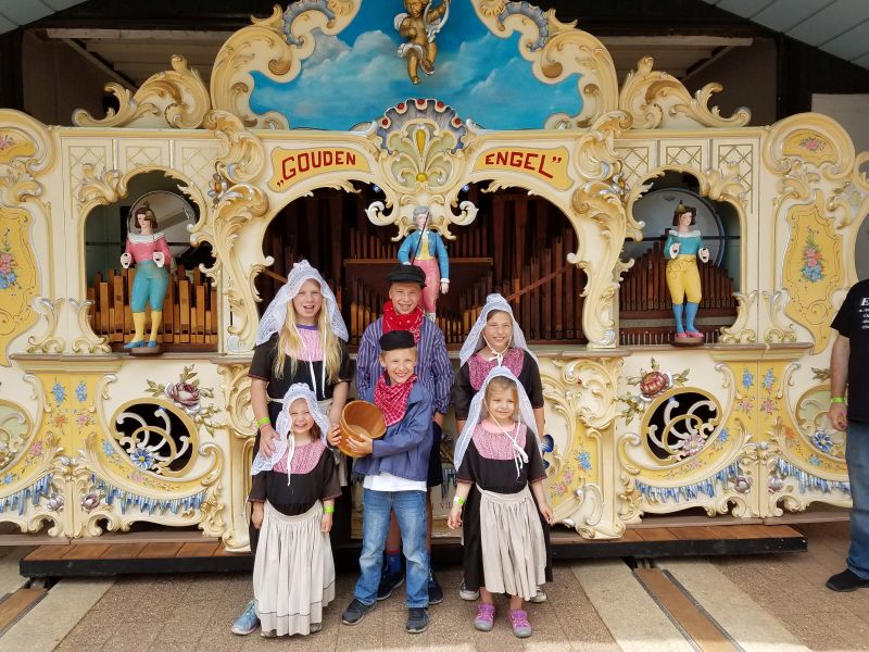 Dutch Village kids in dutch costumes by organ 