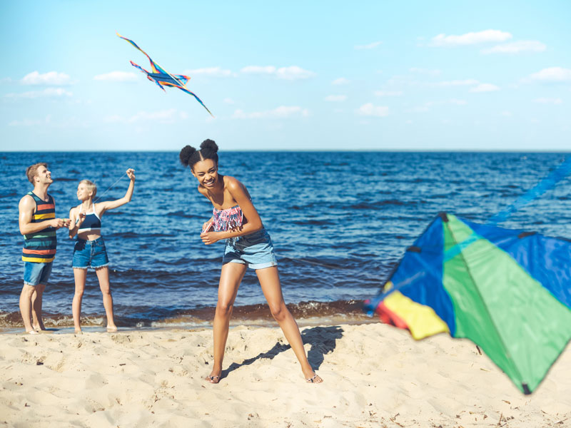 Free summer things to do girl flying kite on beach