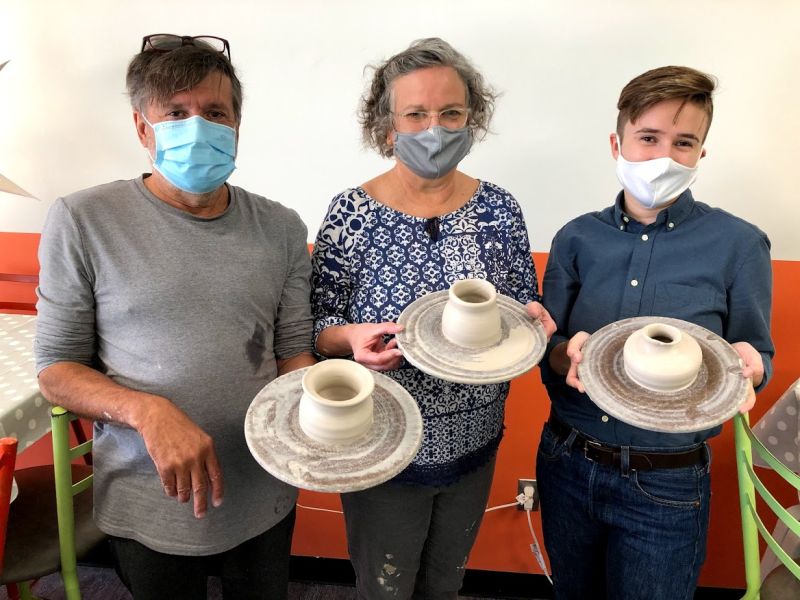 The Mud Room family in masks with potters wheel creations