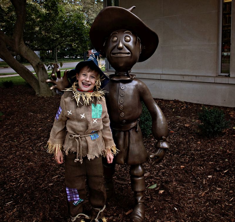 Wizard of Oz garden scarecrow statue and boy in costume Rudd