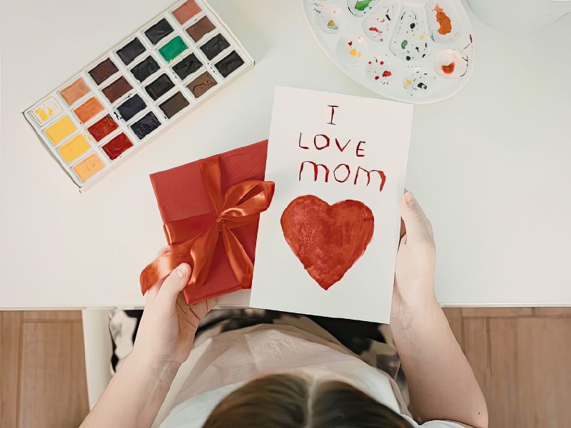 Mother's Day child holding homemade card