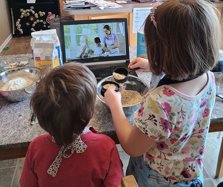 Kids Cook Real Food kids measuring oatmeal with video lesson