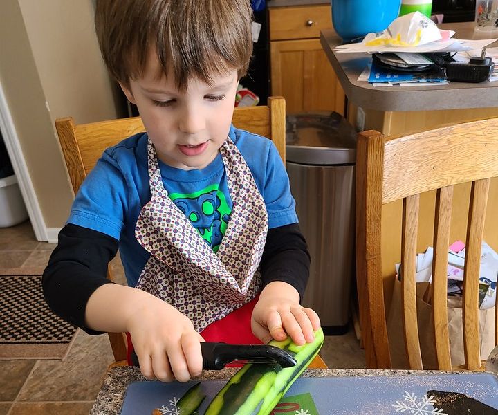 Kids Cook Real Food preschooler peeling cucumber