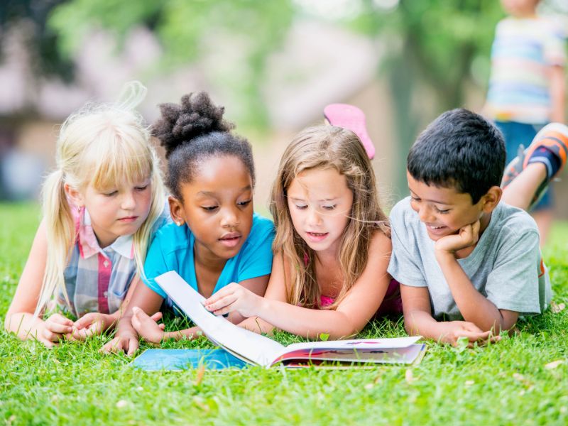 summer reading programs kids reading book outside