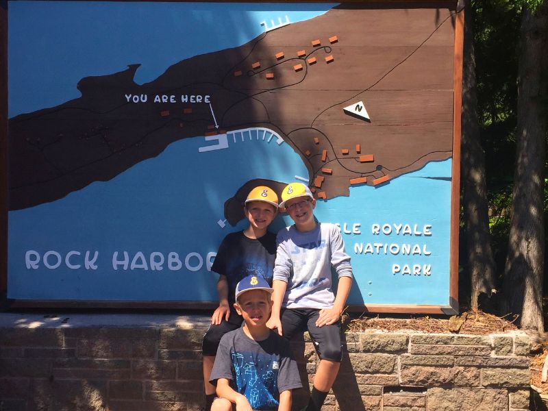 Kids in front of Isle Royale National Park sign