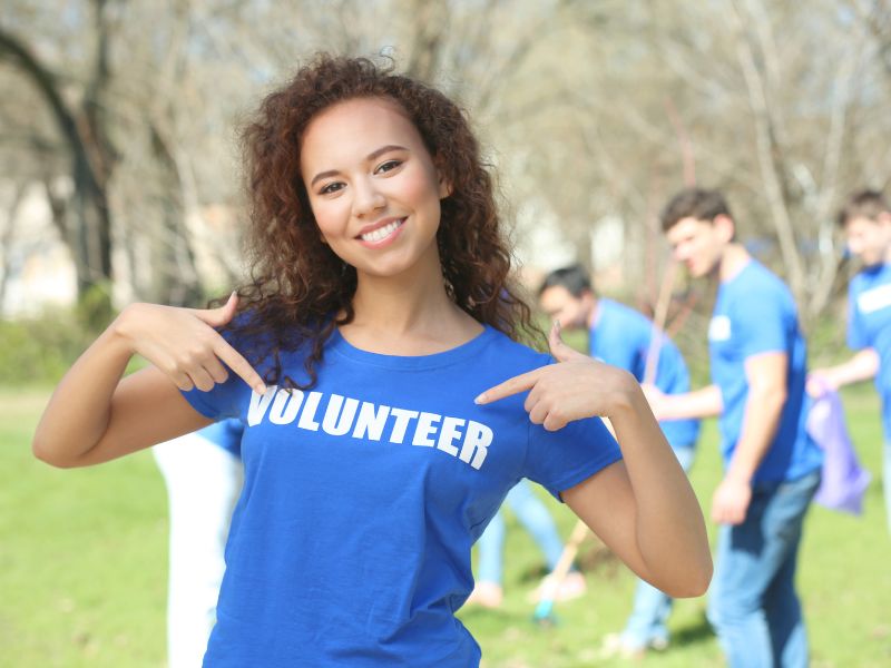 volunteer opportunities woman in volunteer shirt canva