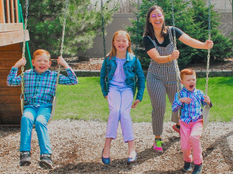 Au Pair in America au pair with three children on swings Facebook