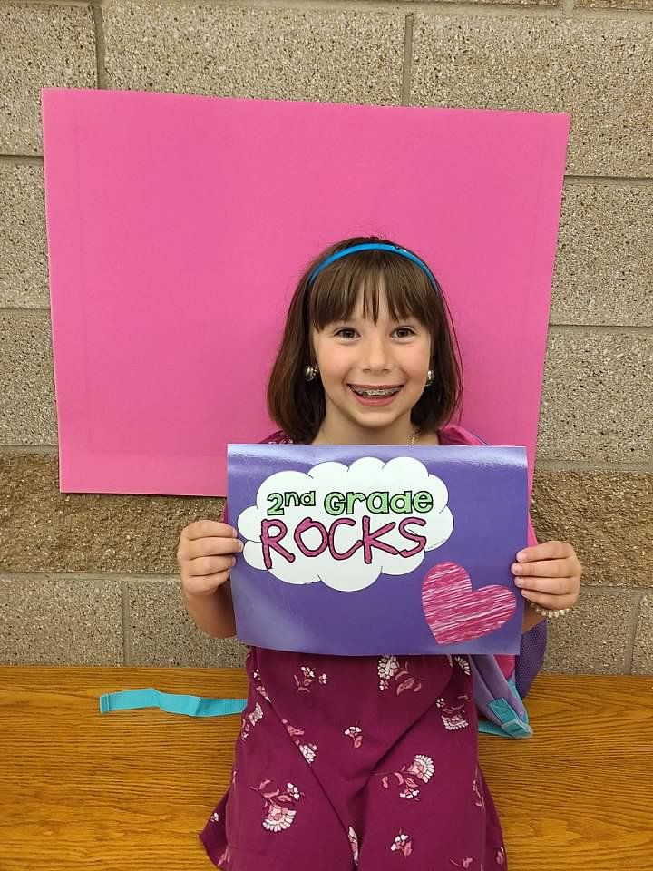 Girl with 2nd grade sign 