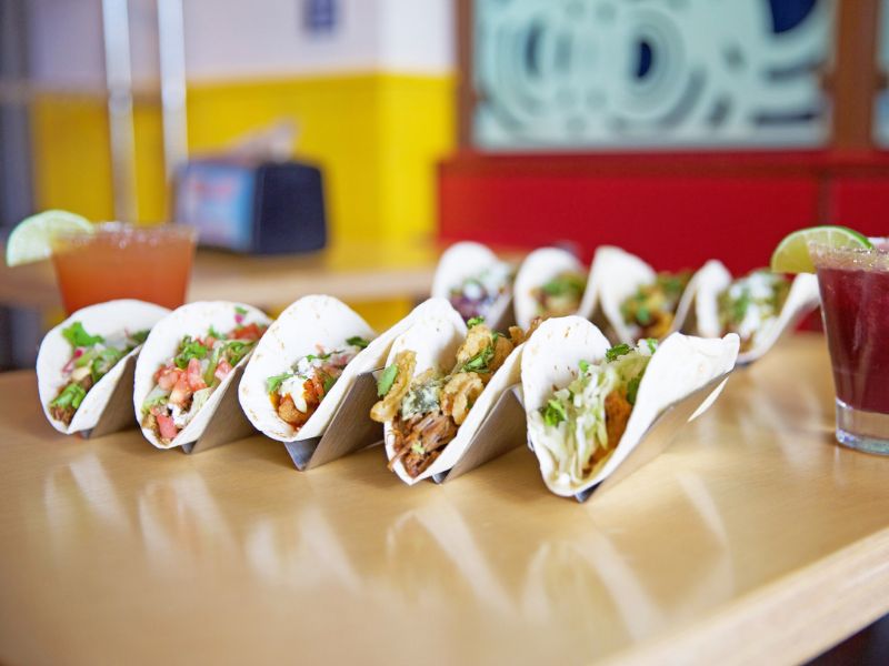 Stans Tacos taco lineup and two margaritas