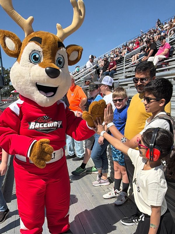 Berlin Raceway Mascot, Bolt the Buck greeting fans between races.