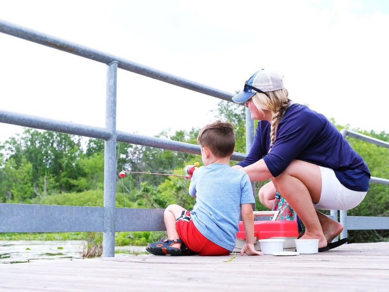 Michigan Free Fishing Weekend, Mother fishes with son.