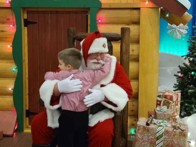 Cabelas Santa boy hugging Santa