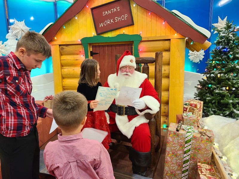 Cabelas Santa kids giving letters to Santa Rudd