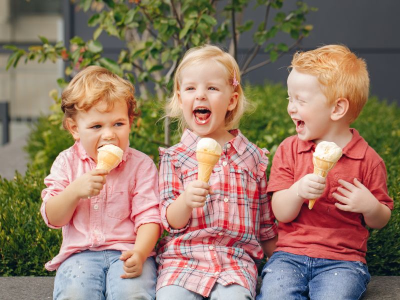 young kids eating ice cream cones canva