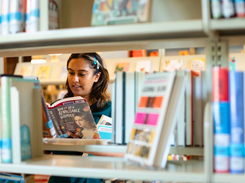 Woman in the stacks at GRPL