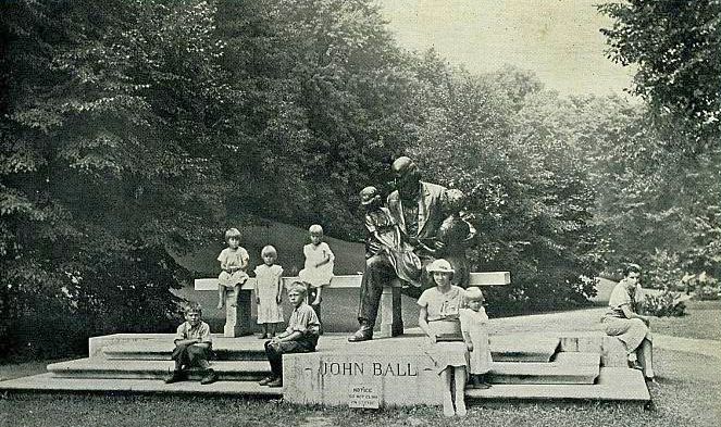 r Historic photo of children posing for a photo next to a sculpture of John Ball at John Ball Zoo in Grand Rapids Michigan