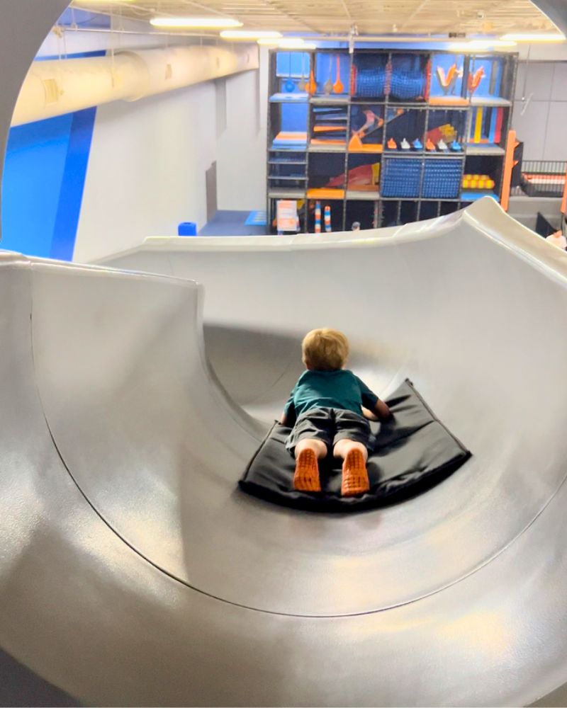 skyzone grand rapids boy at top of curved slide pov 