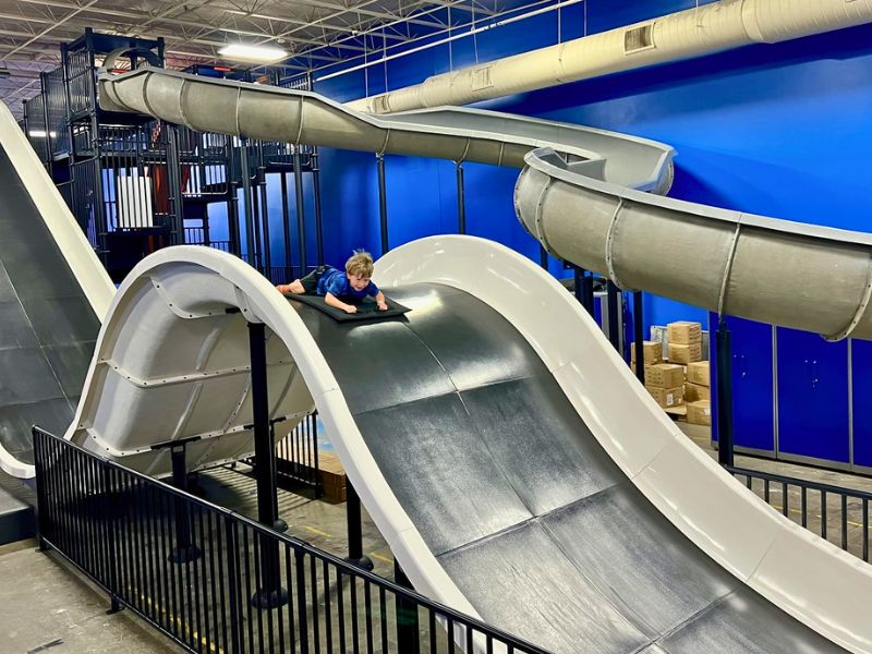 skyzone grand rapids boy on mat on mega slide