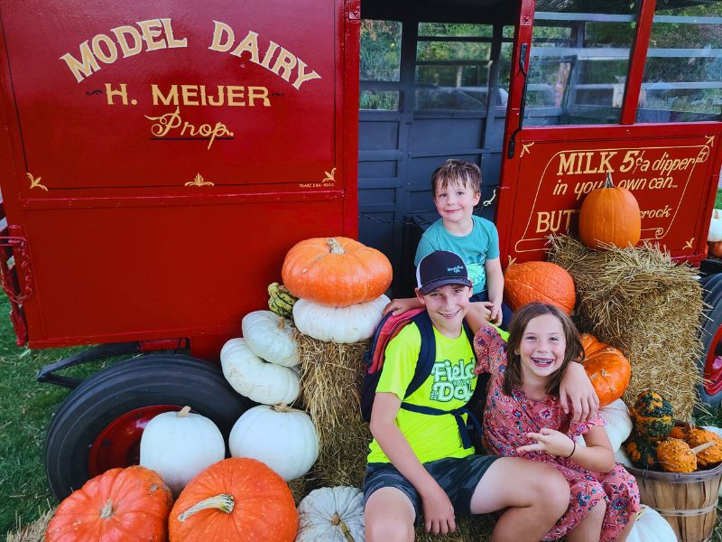 Meijer Gardens fall kids with pumpkins by milk truck