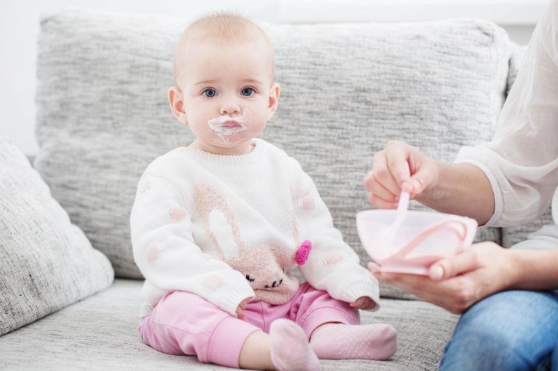 baby with yogurt on face